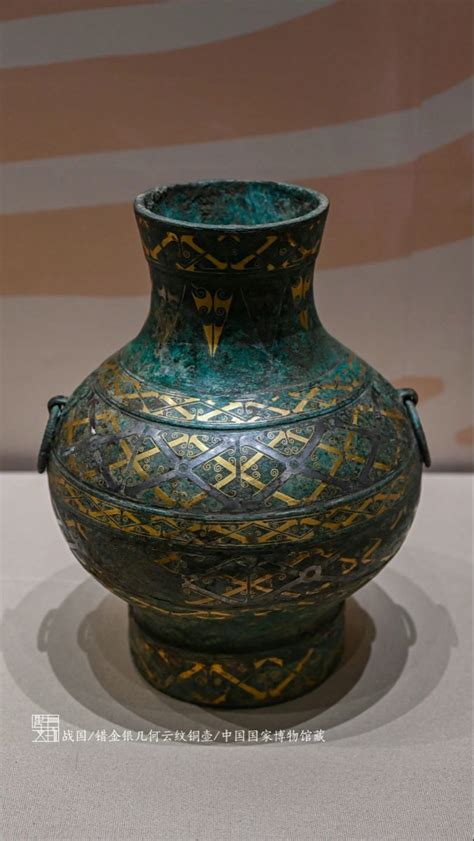 a green vase sitting on top of a white table