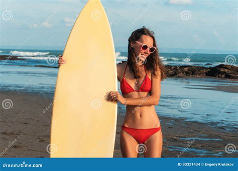 Young Beautiful Woman In Red Bikini And Sun Glasses Holds In Hands A