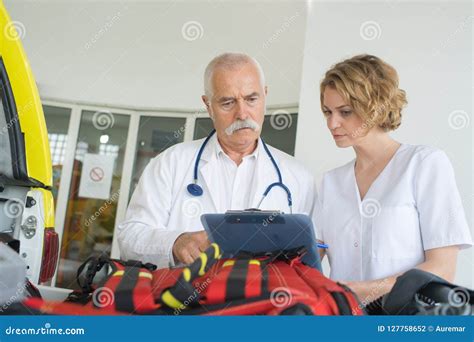 Ambulance Team Laying Patient On Stretcher Royalty Free Stock