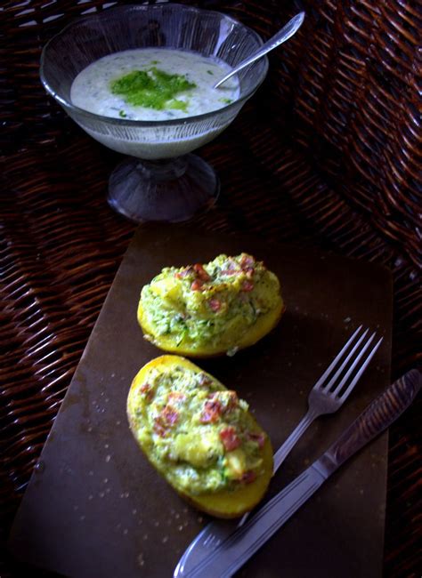 Two Stuffed Potatoes With Guacamole And Salsa On Top Next To A Bowl Of