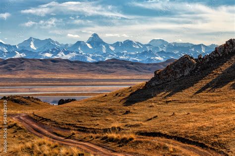 Northern Tien Shan mountain range with Khan Tengri peak in southeast Kazakhstan under a cloudy ...