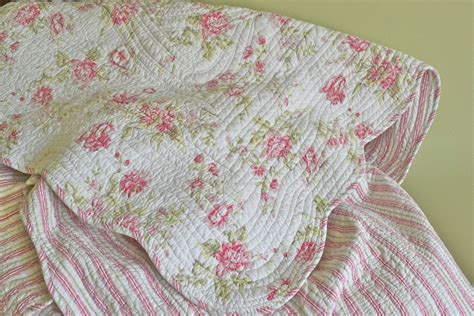 Unmade Bed With Pink And White Flowers