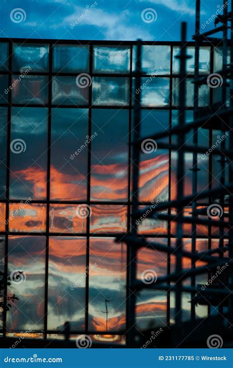 Dramatic Sunset Reflected On The Glass Facade Of A Modern Building