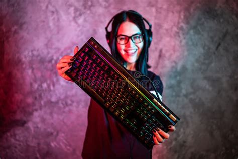 Beautiful Friendly Pro Gamer Streamer Girl Posing With A Keyboard In Her Hands Wearing Glasses