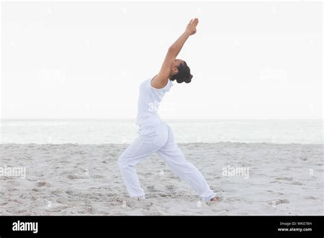 Woman in low lunge yoga pose Stock Photo - Alamy