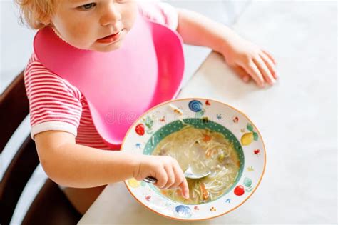 Adorable Baby Girl Eating From Spoon Vegetable Noodle Soup Healthy