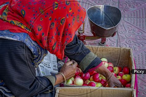 Image Of A Street Vendor Selling Fruits And Vegetables On The Streets