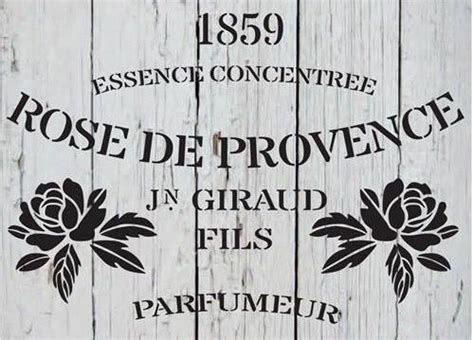 A Sign That Says Rose De Provence On The Side Of A Wooden Fence With