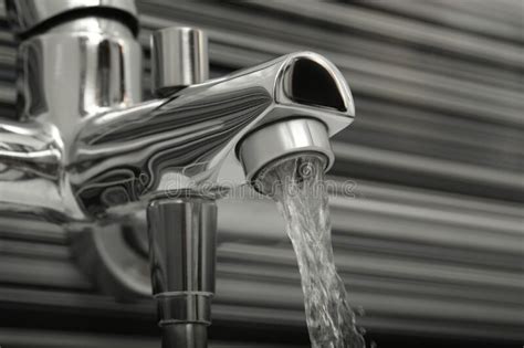 Water Flowing From Bath Tap On Blurred Background Closeup Stock Image