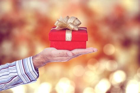 Premium Photo Male Hand Giving A Gift Box