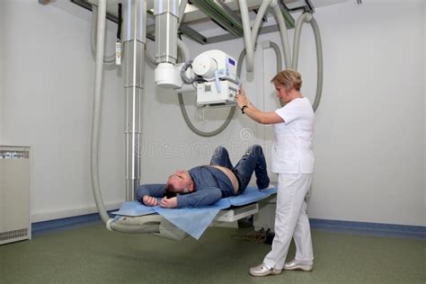 Radiologists Performing X Ray On Patient Technician Setting Up Machine