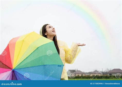 Beautiful Brunette Woman Holding Colorful Umbrella Out In The Rain