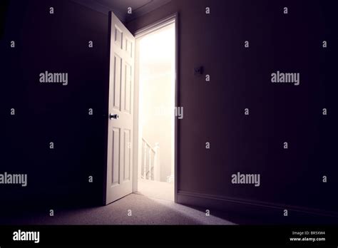 Dark Room With Open Door Light Streaming In Stock Photo Alamy