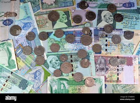 Background of old Libyan money banknote bills and coins of different ...