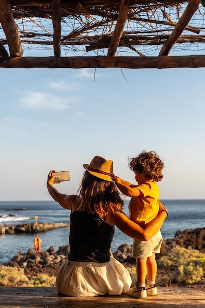 Premium Photo Mother And Son On Vacation Taking A Photo On Tacoron