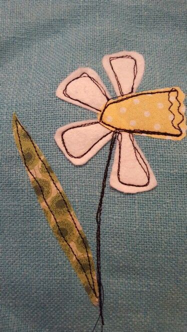 A Close Up Of A Piece Of Fabric With A Flower In The Middle And A Leaf