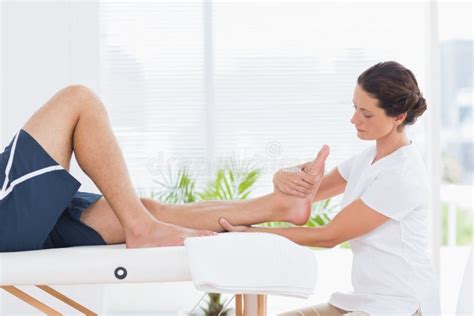 Physiotherapist Doing Calf Massage To Her Patient Stock Photo Image