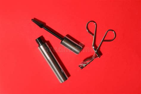 Black Mascara and Eyelash Curler on Red, Flat Lay. Makeup Product Stock ...