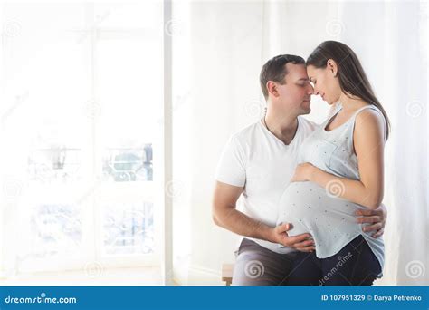 Pregnant Woman And Young Man Together Indoors Stock Image Image Of