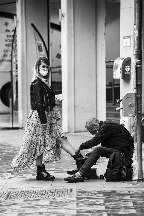 Woman At Shoe Shine In The Street Durinng The Covid 19 Pandemic