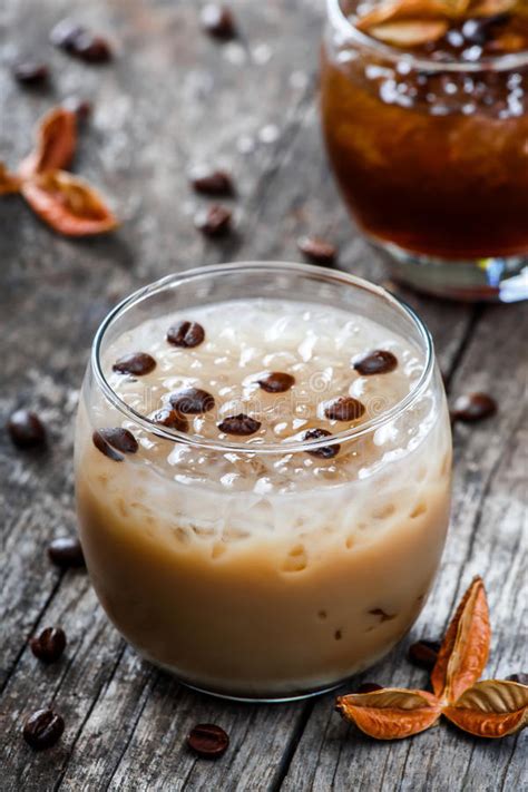 Cold Alcoholic Cocktail With Chocolate In Tall Glass On The Glass Background Backdrop Of The