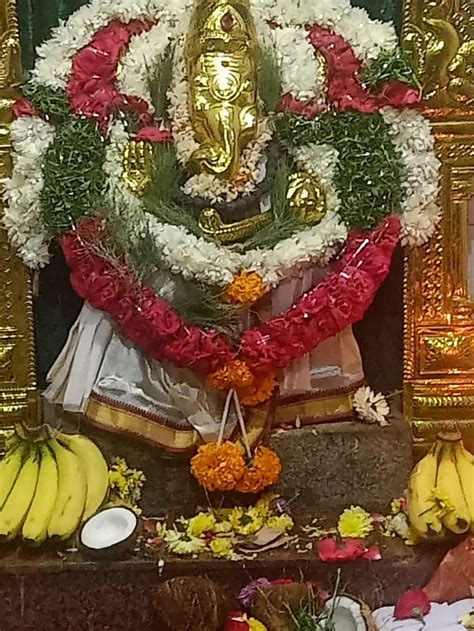 There Is A Shrine With Bananas And Flowers On The Table In Front Of It