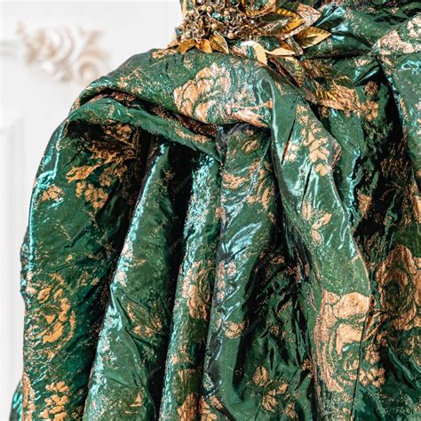 Premium Photo | A green and gold dress with gold leaves on it