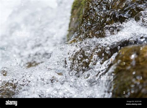 Rushing Water Over Rocks At The Bottom Of A Waterfall On Kaua I Hi