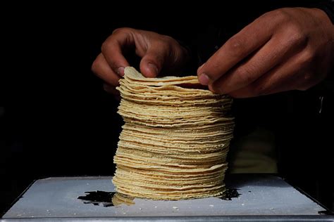 Employee Weighs A Stack Of Freshly Made Photograph By Carlos Jasso Pixels