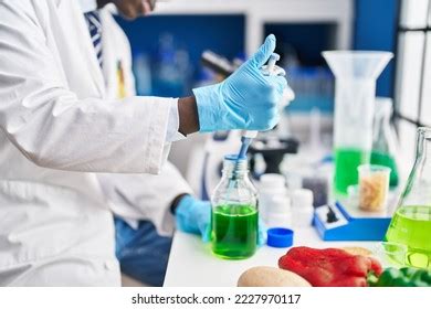 African American Man Scientist Pouring Liquid Stock Photo 2227970117