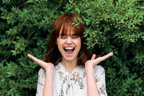 premium photo joyful woman smiling  hands raised  front  face