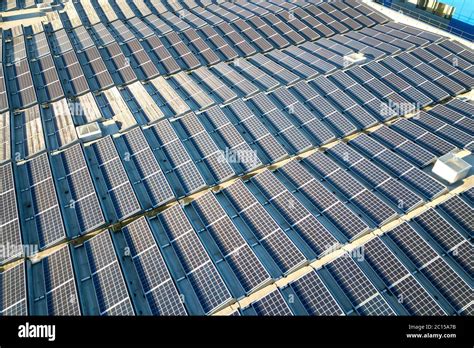 Aerial View Of Many Photo Voltaic Solar Panels Mounted Of Industrial