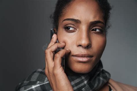 Portrait Of African American Serious Woman Talking On Smartphone Stock