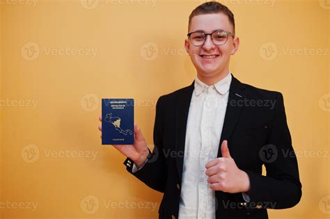 Young handsome man holding Republic of Nicaragua passport id over