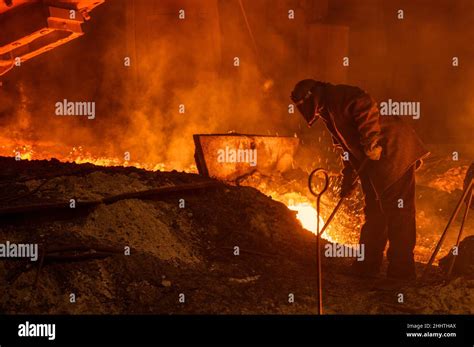 The Process Of Releasing Pig Iron From A Blast Furnace A Man Works