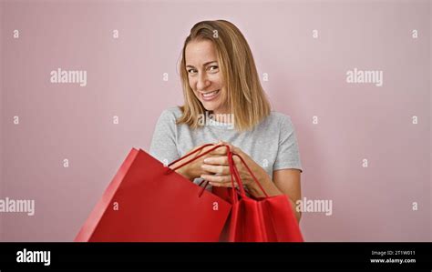 Cheerful Young Blonde Woman Beaming Over A Successful Shopping Haul