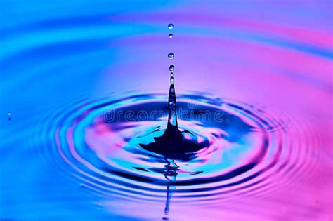 A Drop Of Water Falling Into The Water And Creating Waves Stock Image