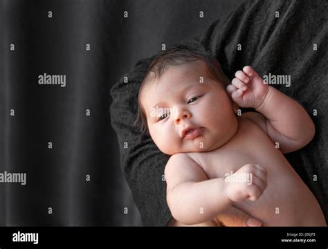 Newborn Baby On A Black Background Baby Resting In Mothers Hand