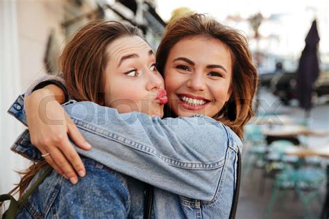 Close Up Photo Of Two Happy Pretty Woman Friends In Jeans Jacket