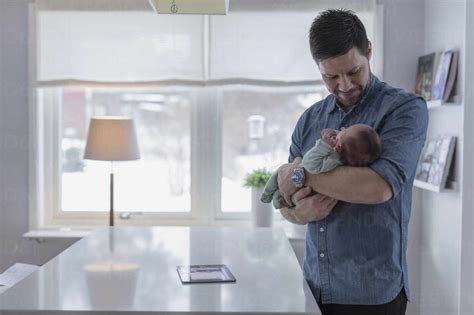 Man Holding Baby In Arms Stock Photo