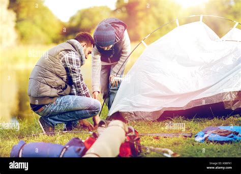 Happy Father And Son Setting Up Tent Outdoors Stock Photo Alamy