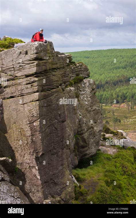 A Hiker Lying Down Taking In The Views Of The Countryside From The Top