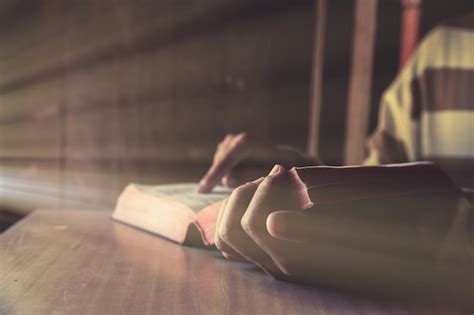 Premium Photo Midsection Of Man Reading Bible On Table