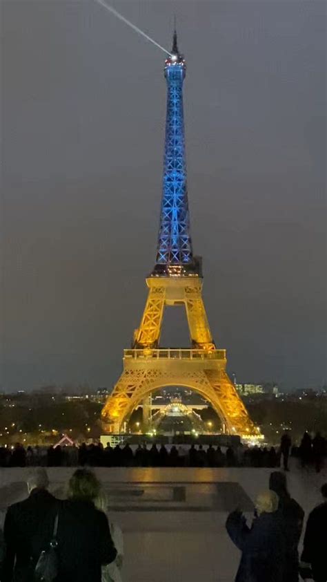 Eiffel Tower Lights Up In Blue And Yellow Ahead Of First Anniversary Of