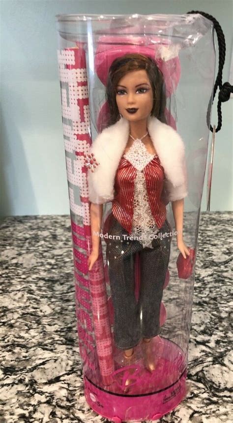 A Barbie Doll In A Pink And White Outfit