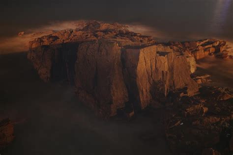 Premium Photo | A dark landscape with a cliff and a dark sky with a ...