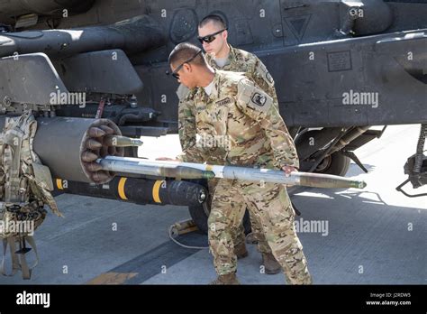 U S Army AH 64E Apache Helicopter Ground Crew Members Assigned To Task