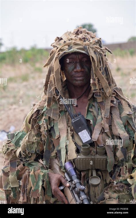 A Nigerian Army special forces sniper poses during a demonstration of ...