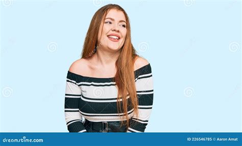 Young Beautiful Redhead Woman Wearing Elegant Clothes Looking Away To