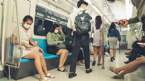 Crowd Of People Wearing Face Mask On A Crowded Public Subway Train